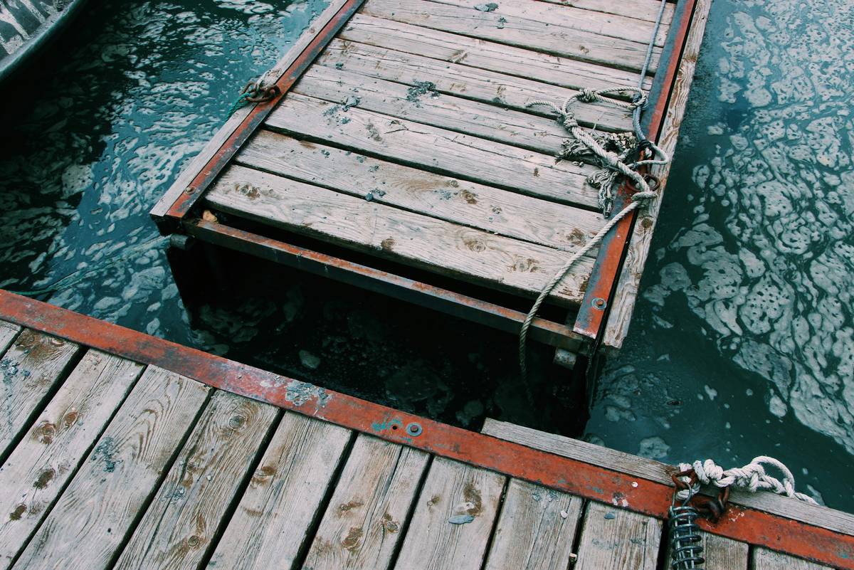 Close-up of a scratched fiberglass boat hull with text overlay: Boat Damage Coverage protects against repair costs like this