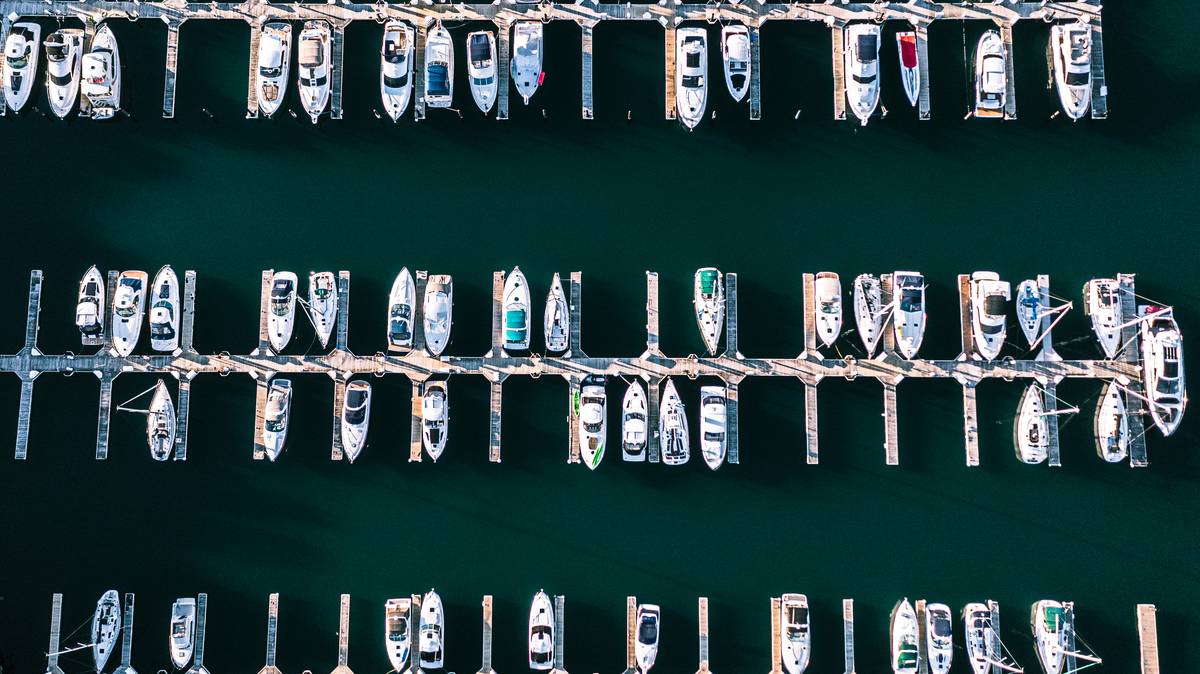Damaged rental boat at dock with personal boat rental insurance claim form nearby